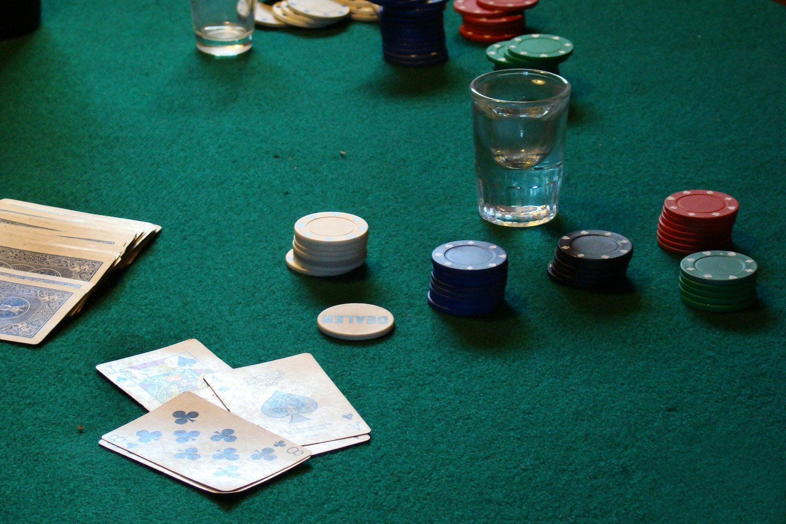 Playing cards and poker chips on a felt table